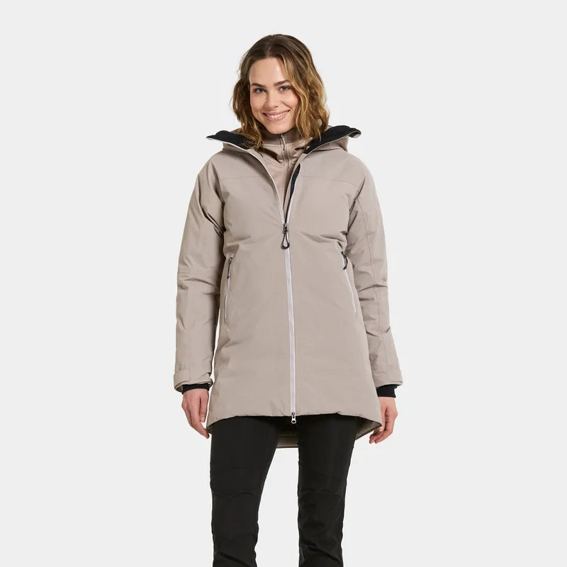 Woman wearing a beige jacket on a white background