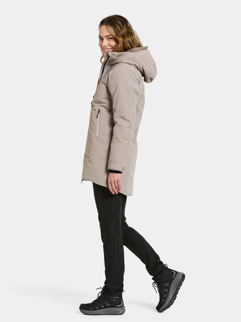 Woman wearing a beige parka on a white background