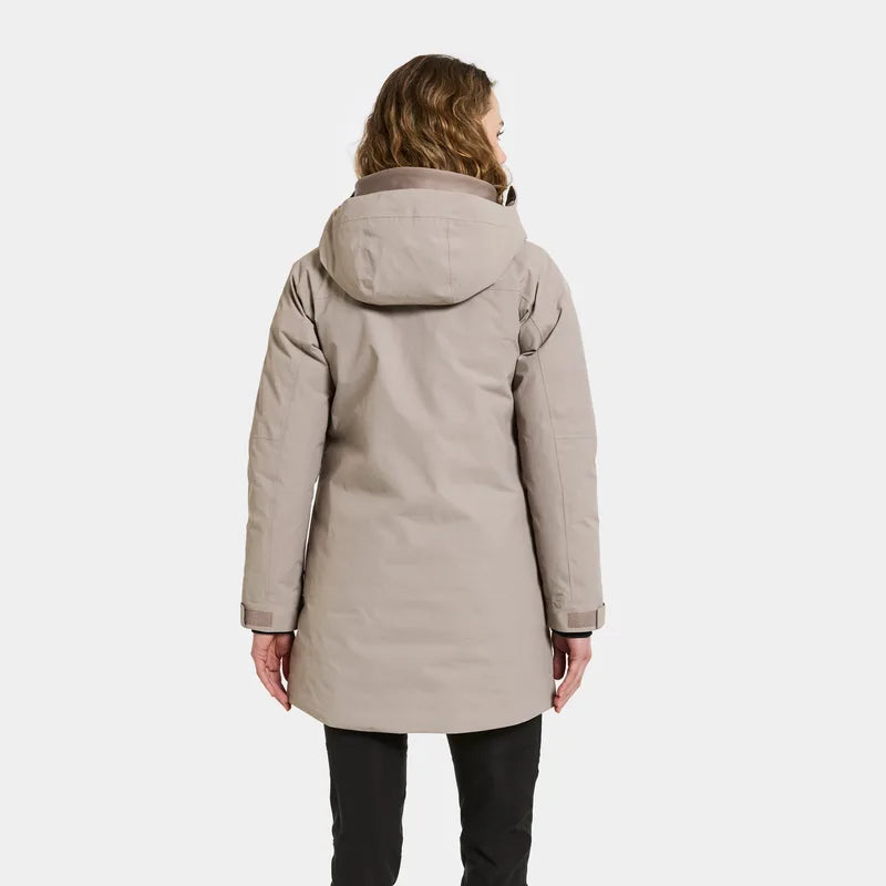 Person wearing a beige parka coat on a white background