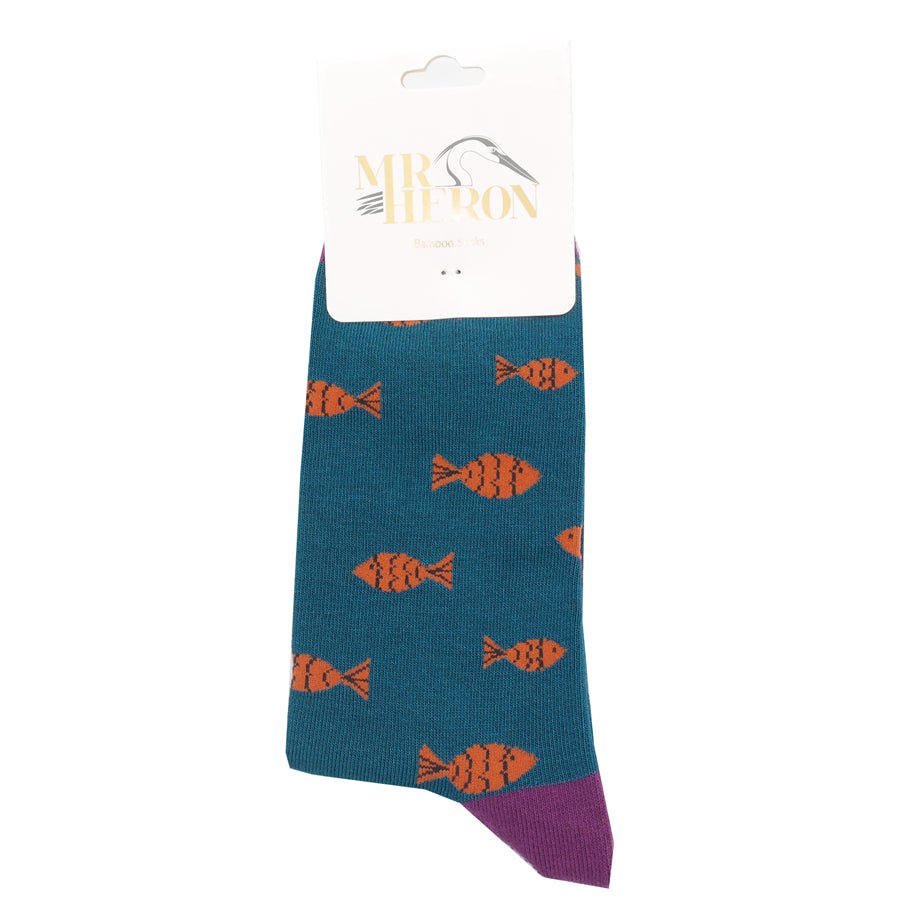 Teal socks with a repeating pattern of orange fish, purple cuff, and attached Mr. Heron Bamboo Socks tag.