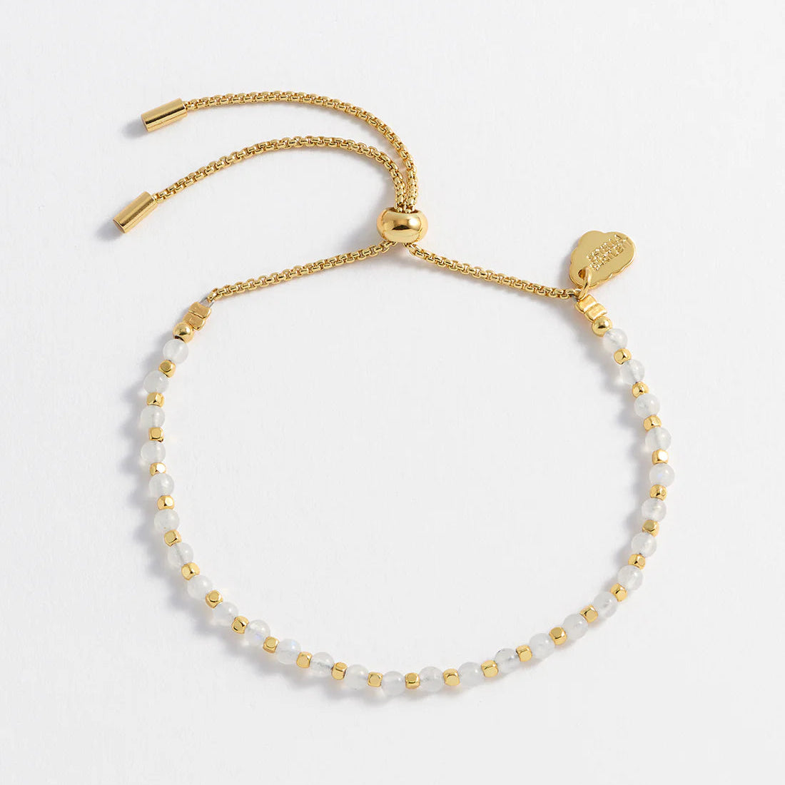 Gold adjustable bracelet featuring moonstone beads and gold spacers.
