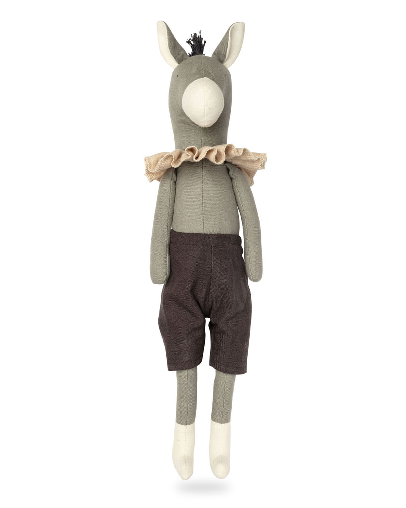 Stuffed toy donkey wearing a sweater and shorts on a white background