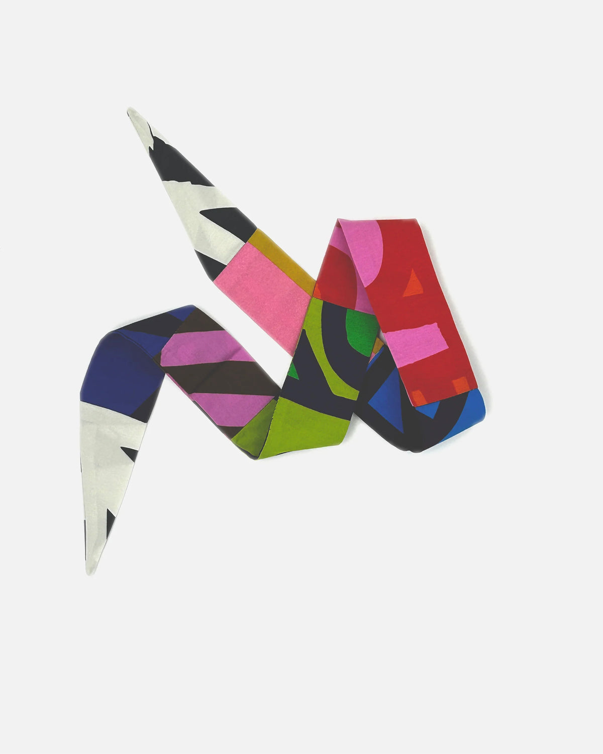 A multicolor abstract geometric scarf with a modern, folded design featuring pink, red, green, blue, black, and white shapes, displayed on a clean light gray background.