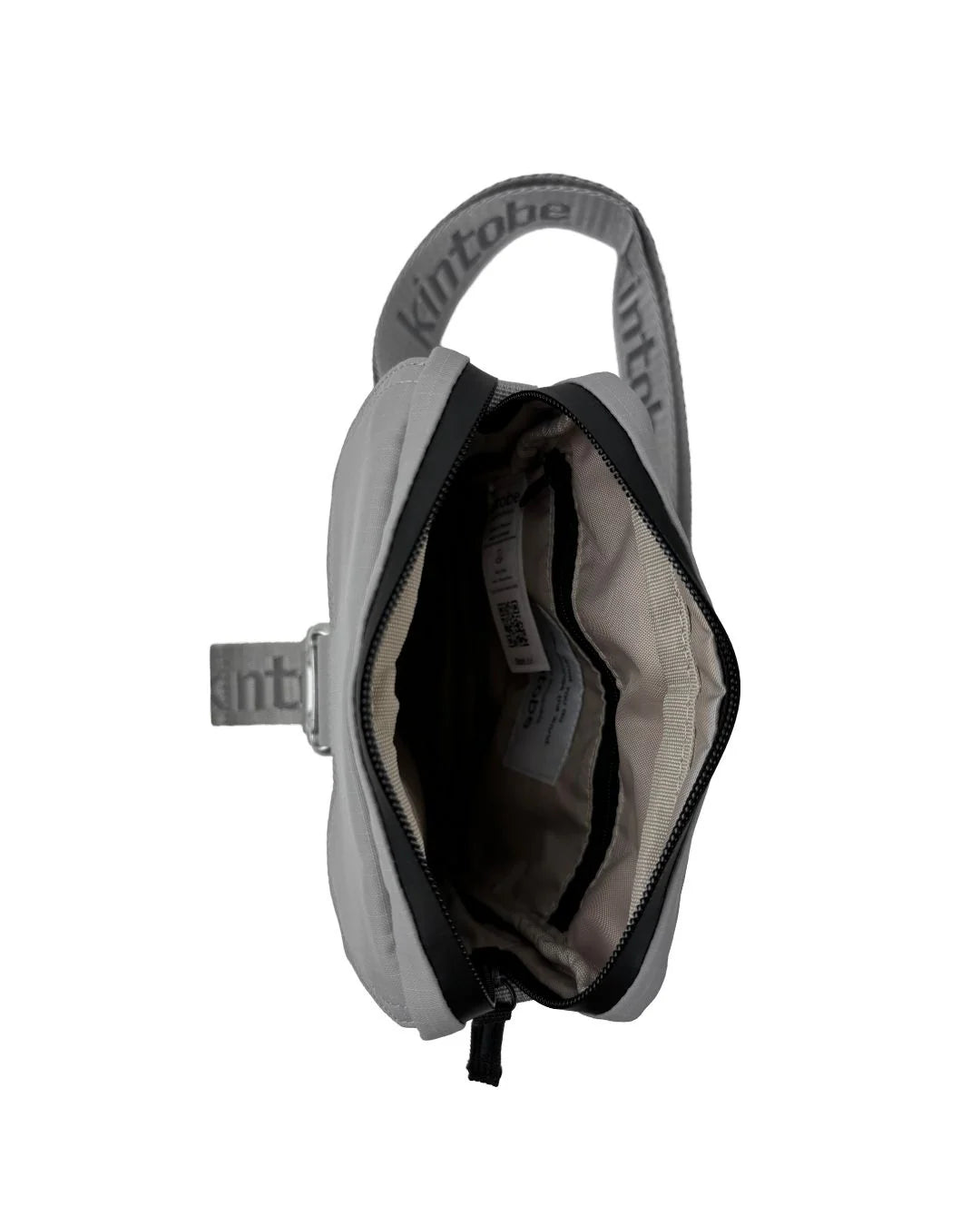 Gray Kintobe crossbody bag with zipper closure, open to reveal interior compartments and strap detail.