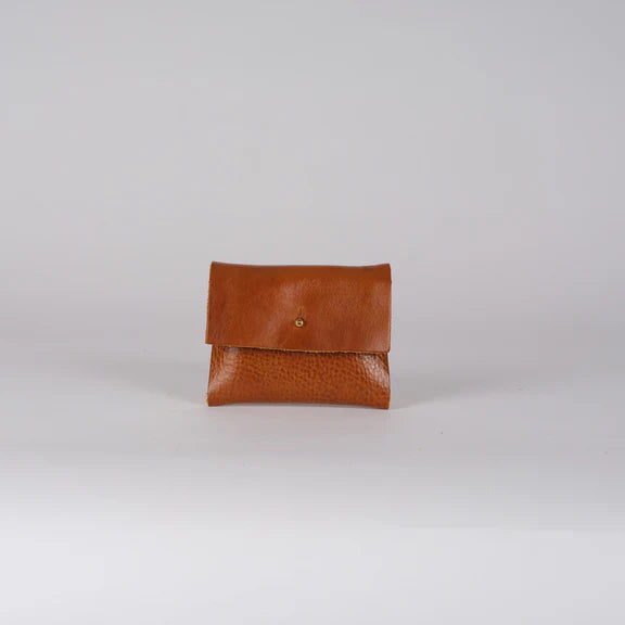 Small brown leather wallet with a textured surface and a single brass fastener.