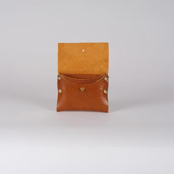 Small, light brown leather wallet open to reveal interior.  The wallet has a textured surface and brass-colored studs.