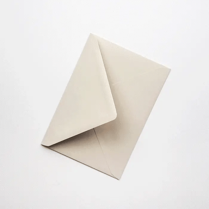 A light beige envelope lies on a white background; the flap is folded over.