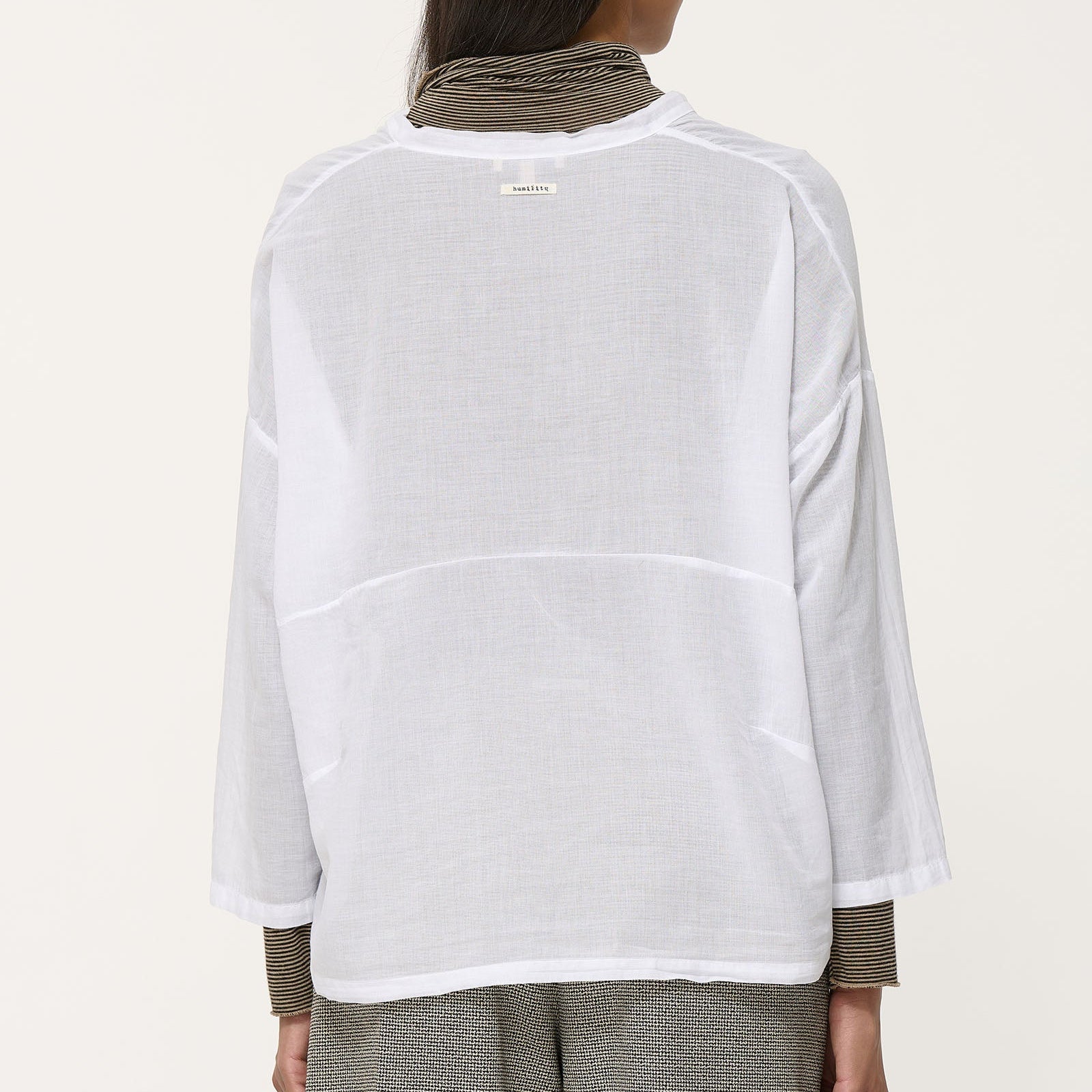 White, lightweight, three-quarter sleeve blouse with a boxy fit and subtle texture.