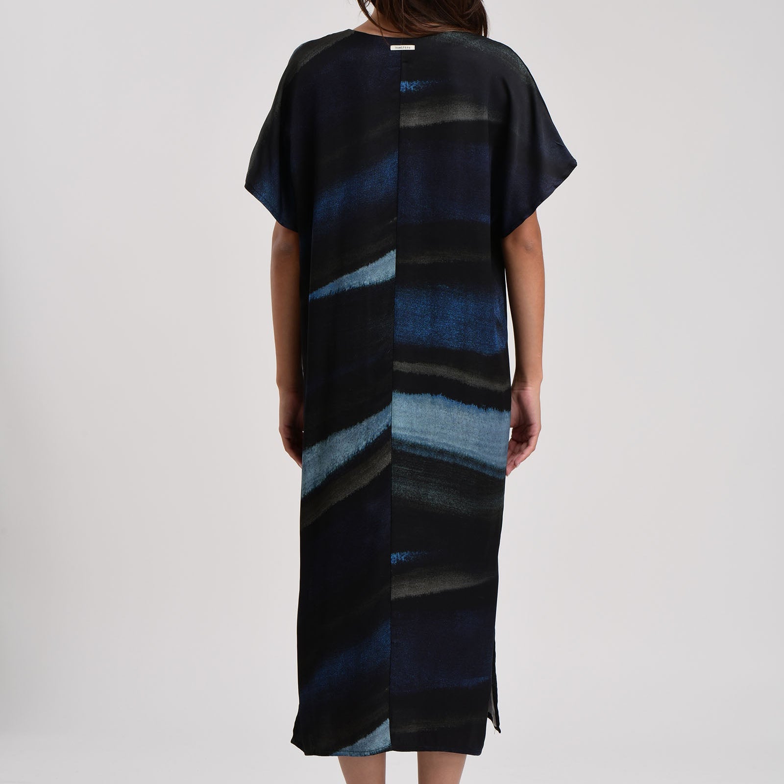 Midi dress with short sleeves and an abstract blue and black watercolor print.  The dress has a relaxed fit and side slits.
