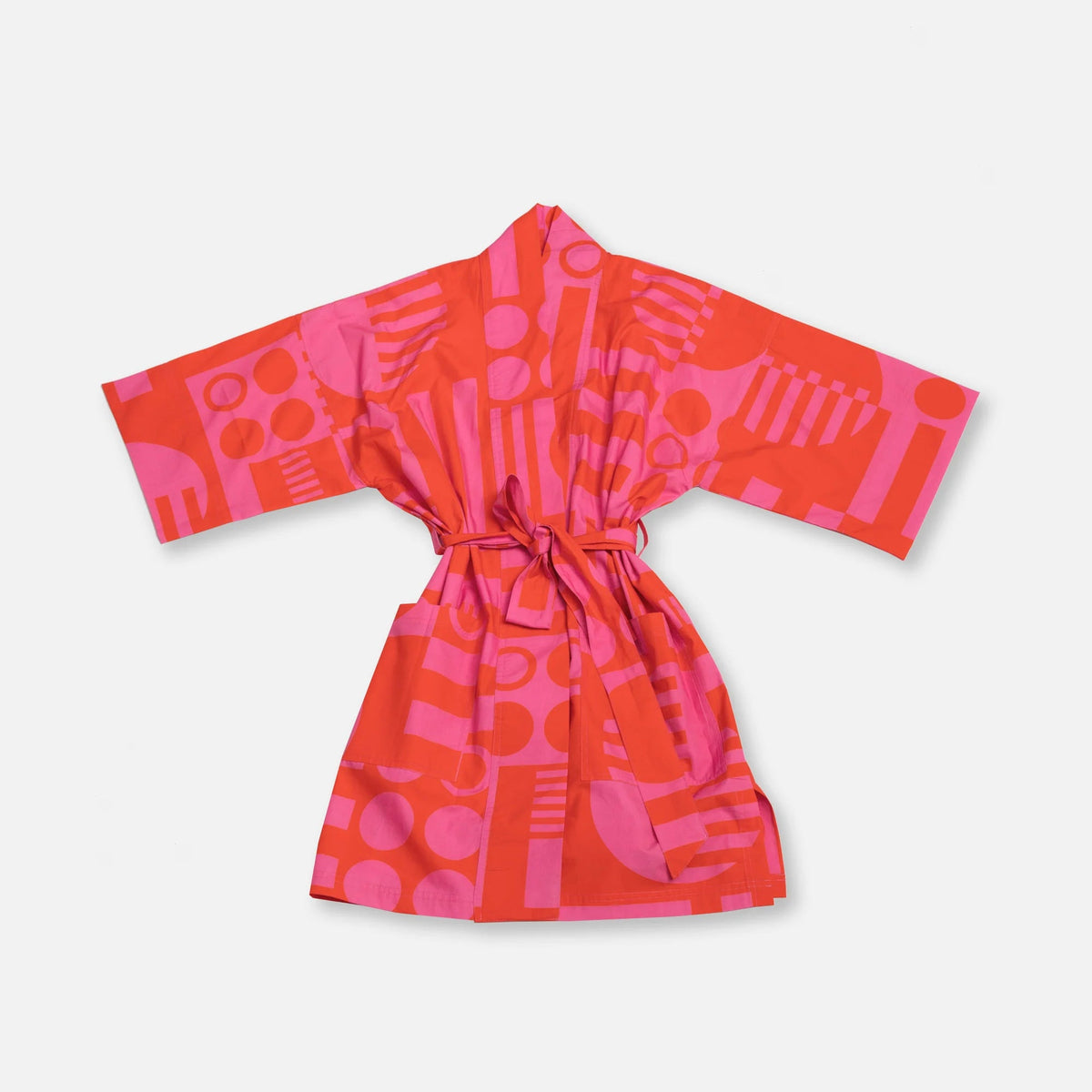 A short-sleeved tie-front robe with a bold abstract geometric pattern in bright pink and coral red, displayed flat against a light gray background.