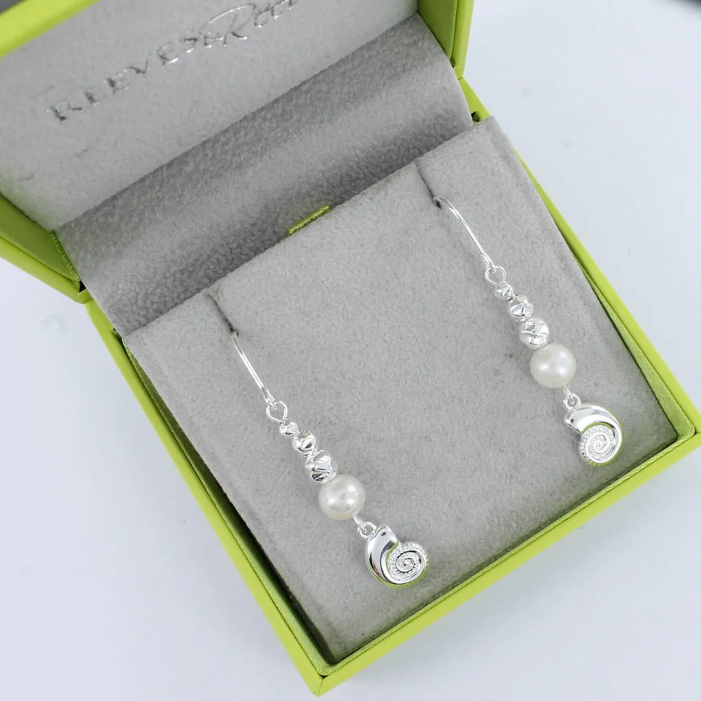 Silver drop earrings featuring a pearl, textured beads, and a shell charm.