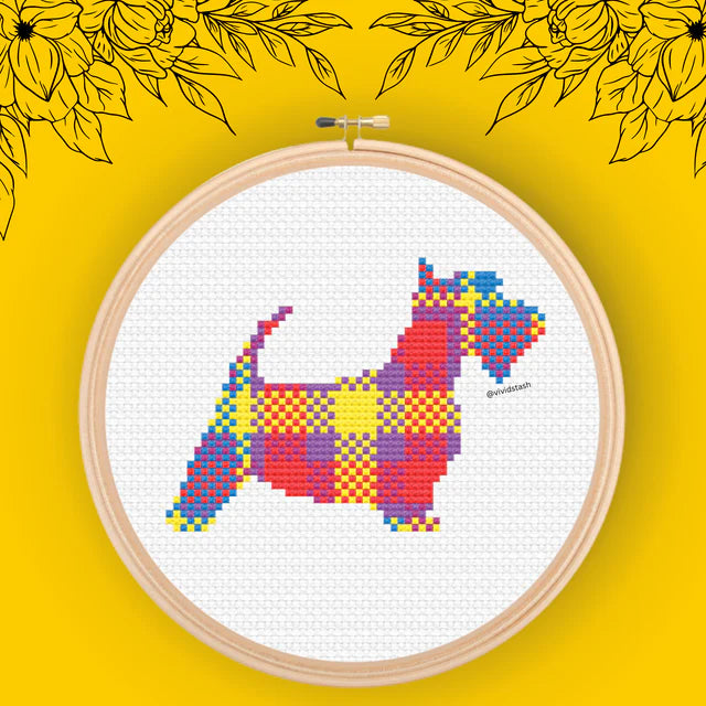 Cross-stitch pattern of a Scottish Terrier in a multicolored plaid design.