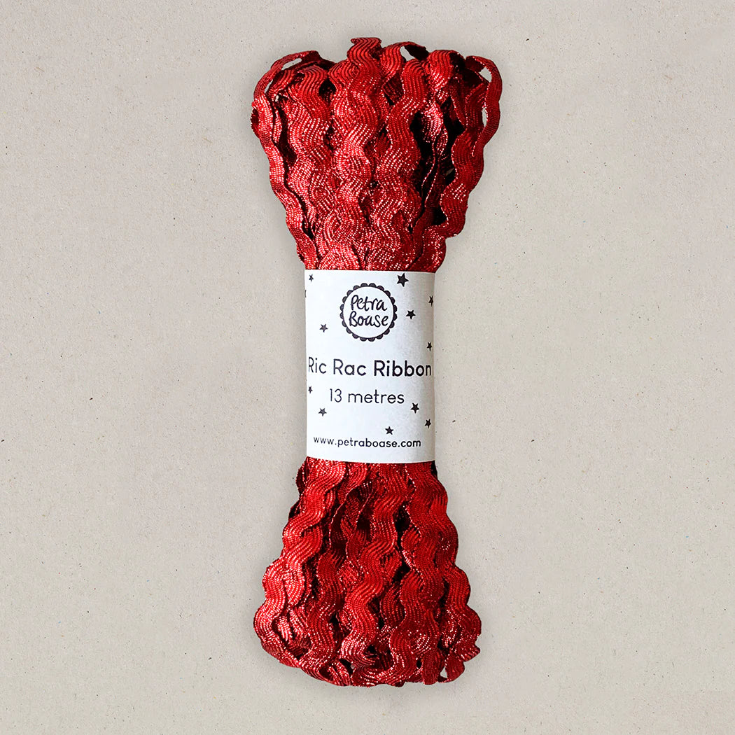 Thirteen meters of red metallic Ric Rac ribbon. The ribbon is wavy and packaged on a label.