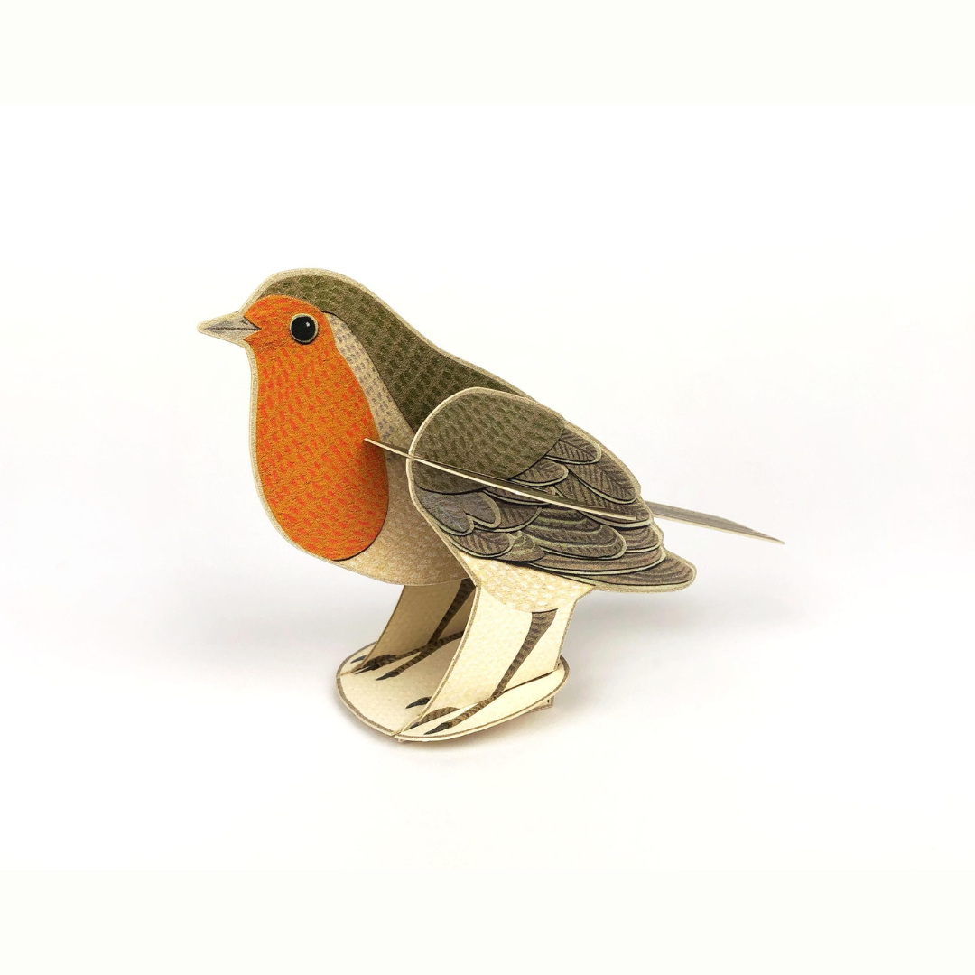 Papercraft robin, detailed illustration of a robin's plumage, standing on cream-colored legs.