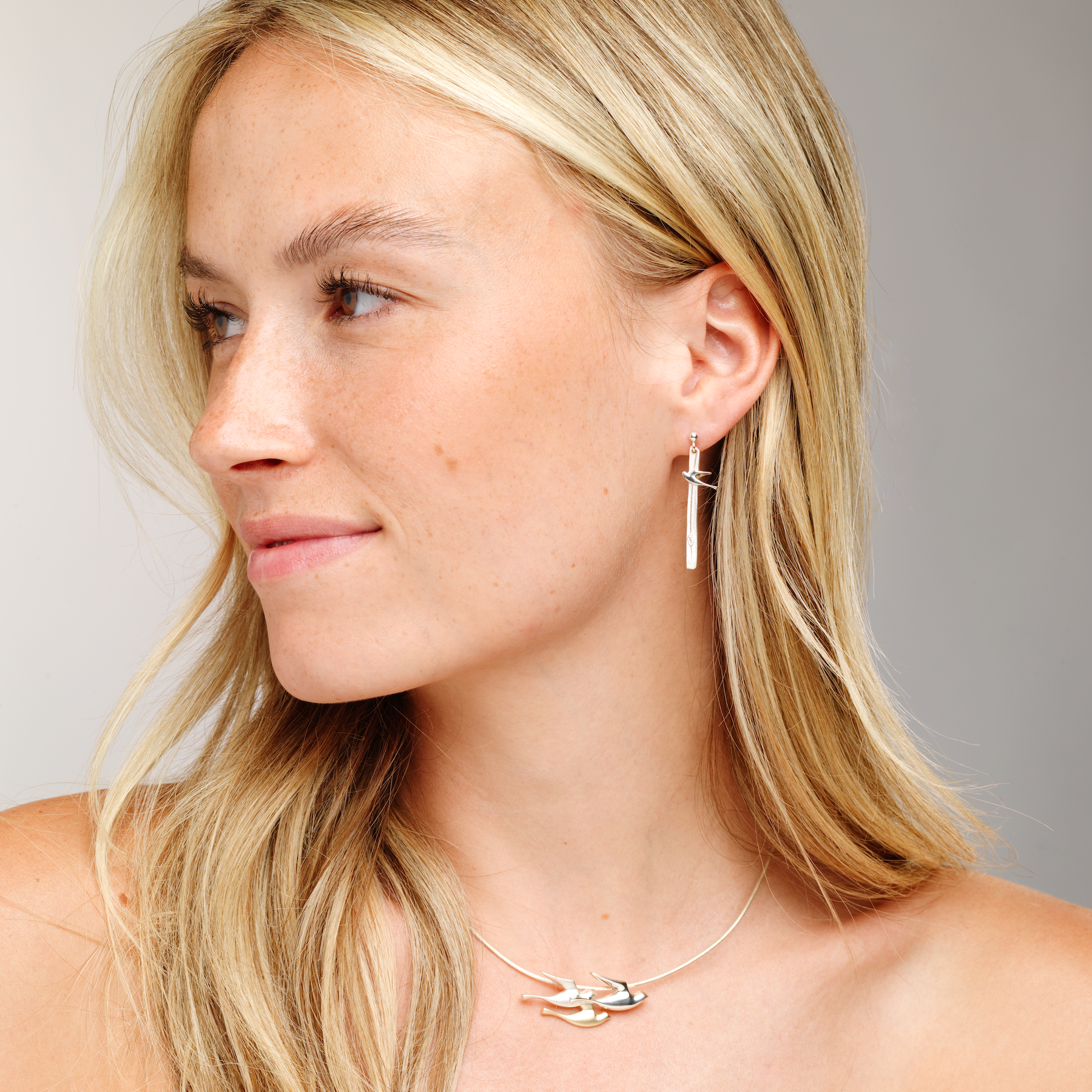 Woman with birdland necklace and drop earring