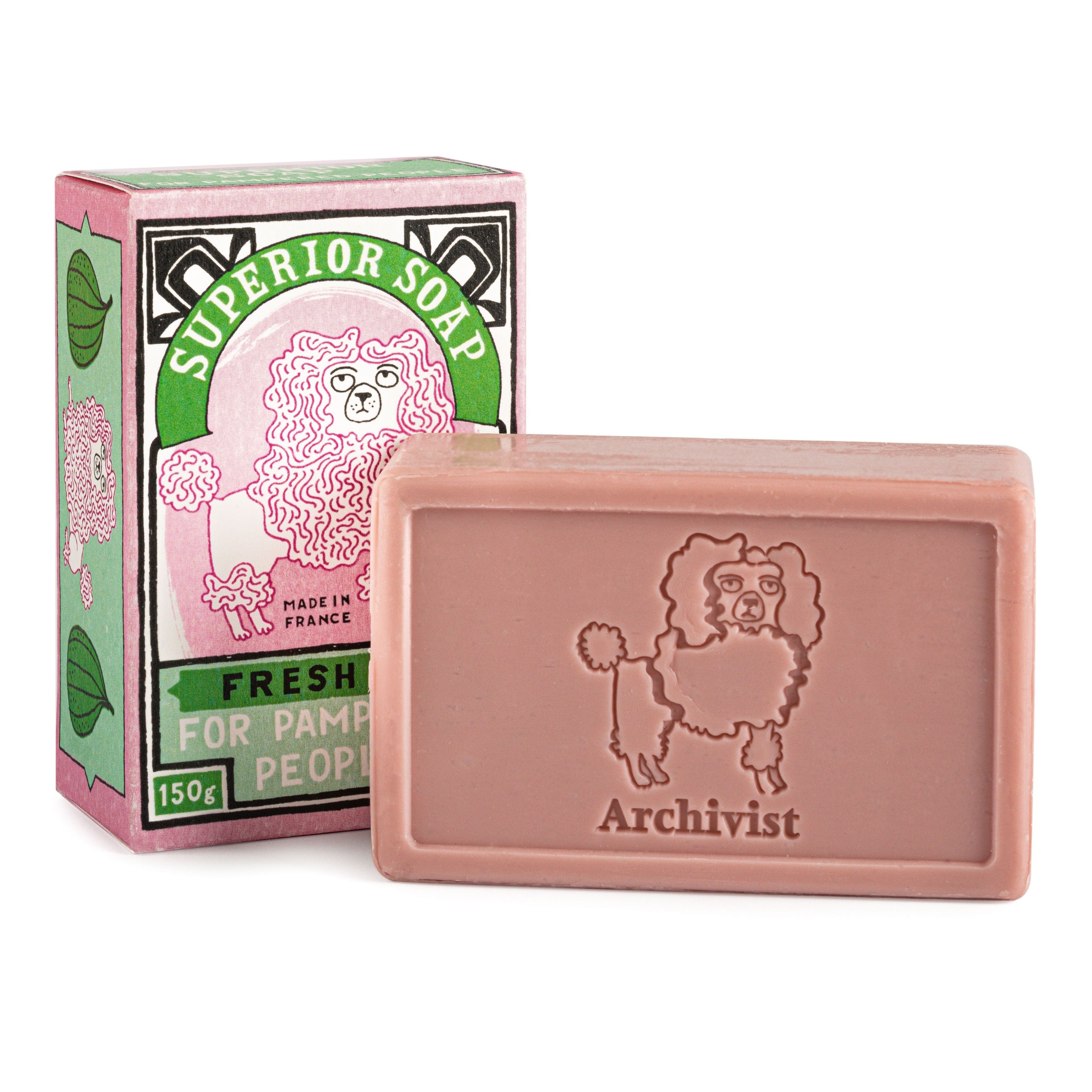 A 150g bar of Archivist Superior Soap, light pink, with a poodle illustration on the soap and its box. Made in France.