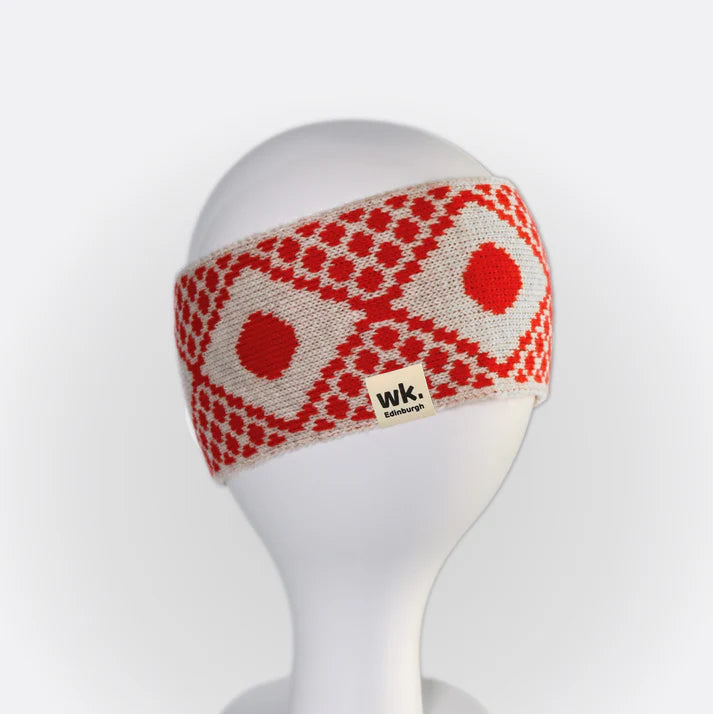 Knit headband in off-white with a red geometric pattern.