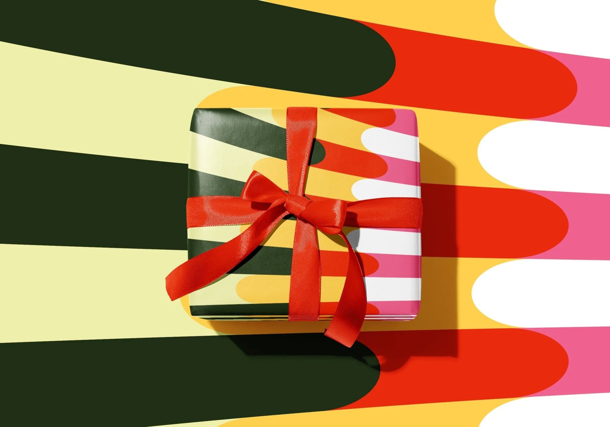 Gift box with a red ribbon on a colorful striped background