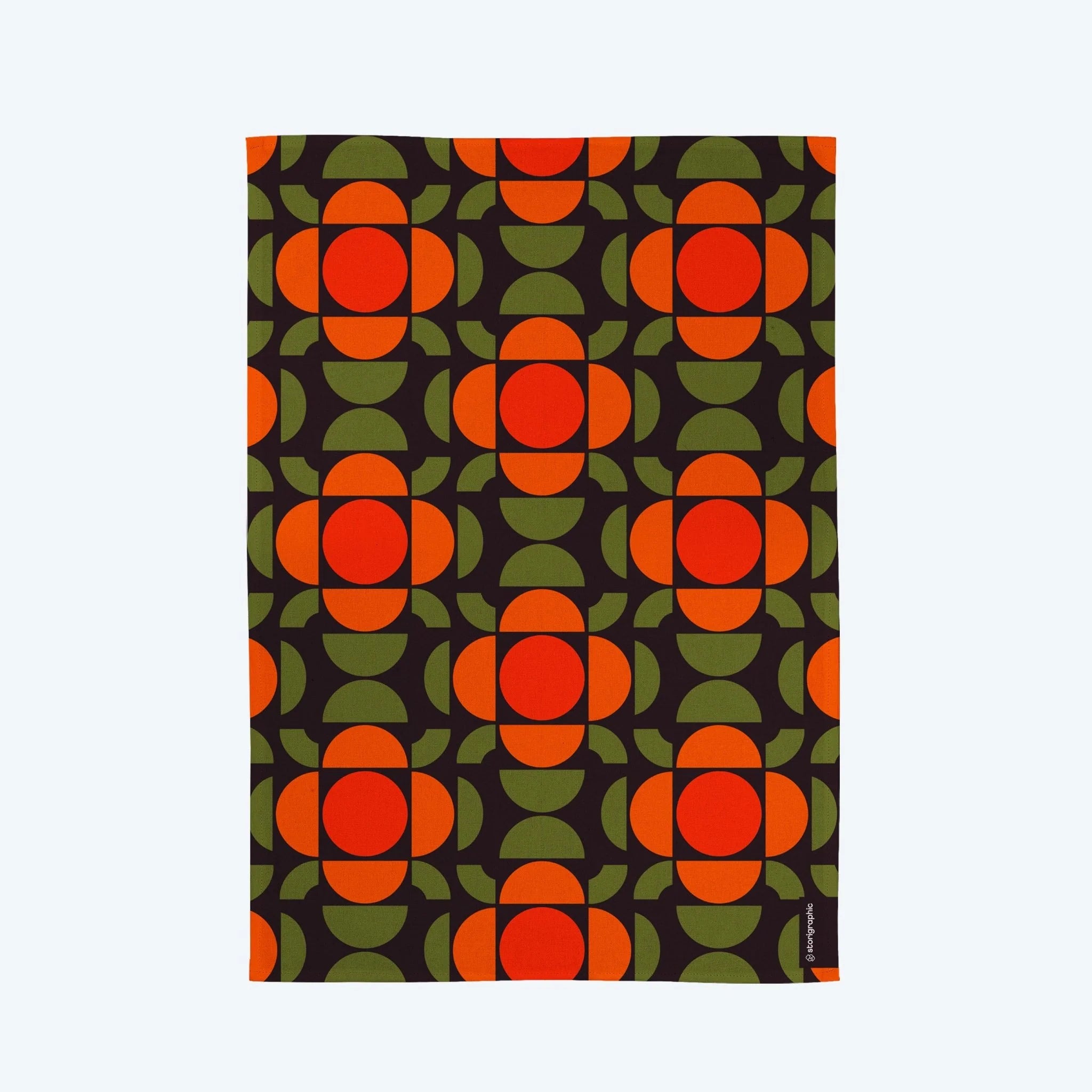 Patterned fabric with red and green shapes on a black background