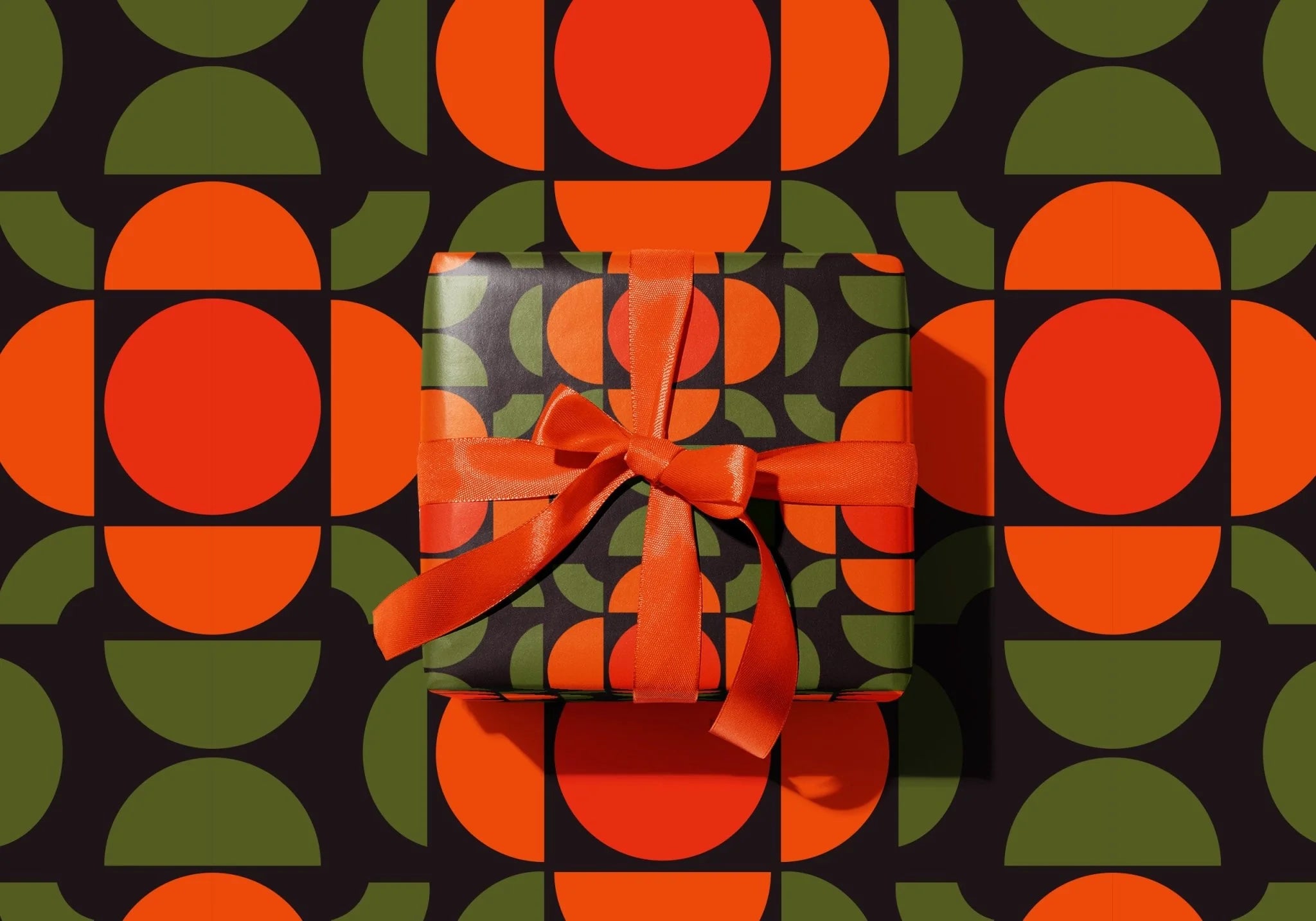 Gift box with a bow on a patterned background