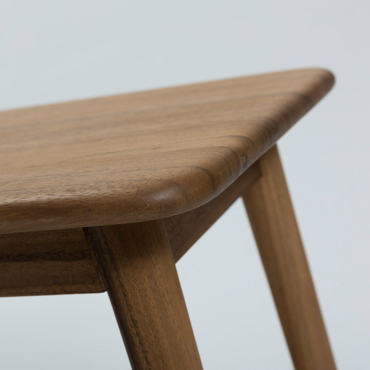 Mid-century modern style wooden coffee table with rounded edges and tapered legs.