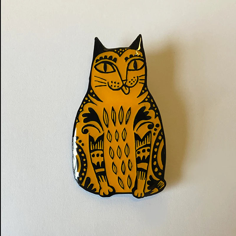 Decorative cat-shaped object with black patterns on a white background