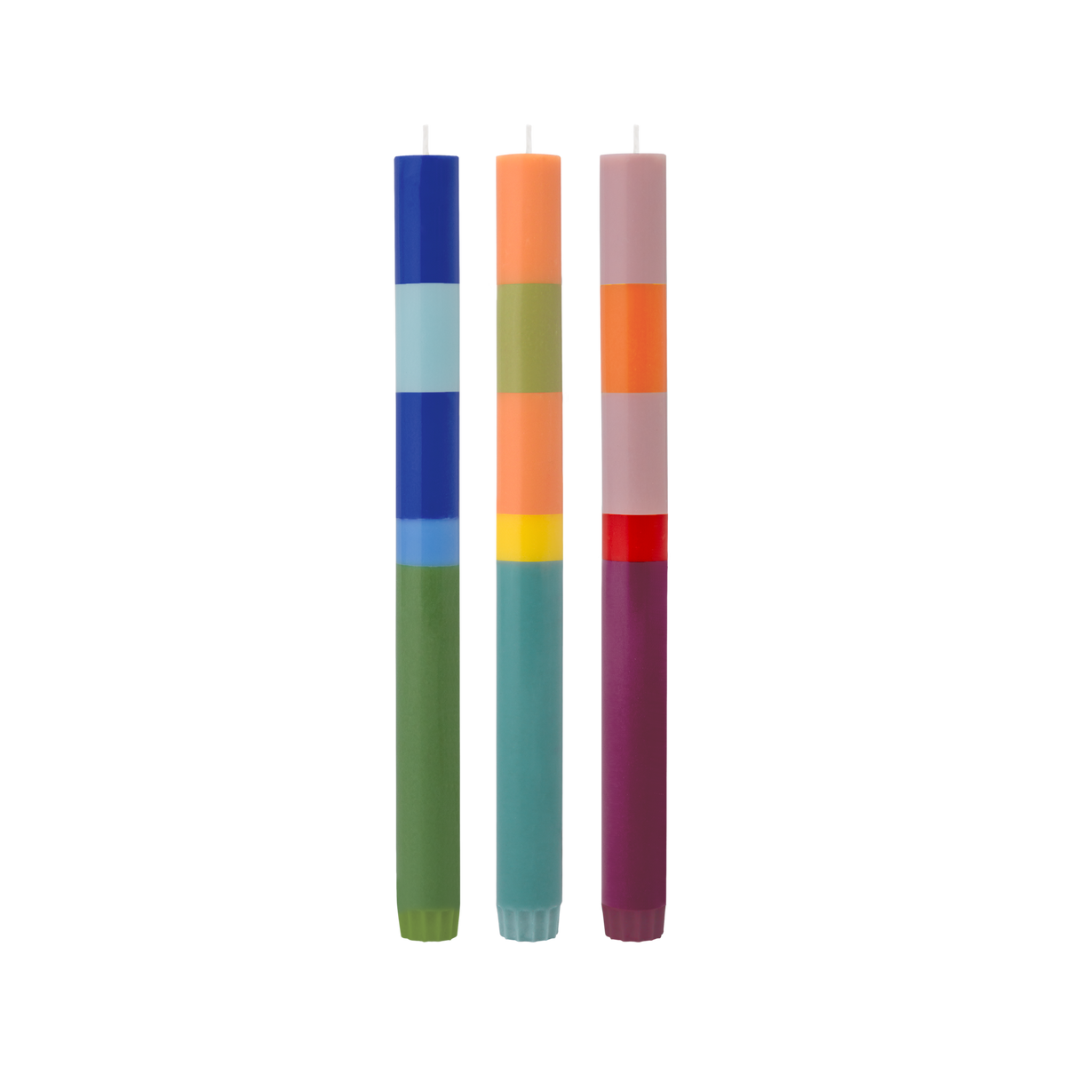 Three colorful candles with striped patterns on a white background