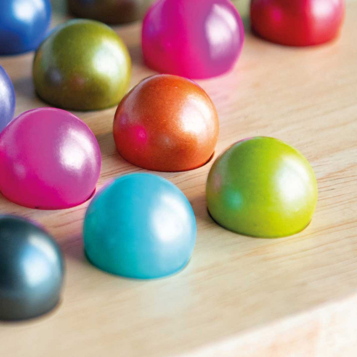Colorful wooden balls on a wooden surface