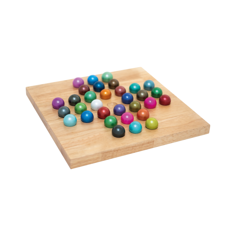 A square wooden board holding a scattered collection of small glossy multicolored balls on a plain white background.
