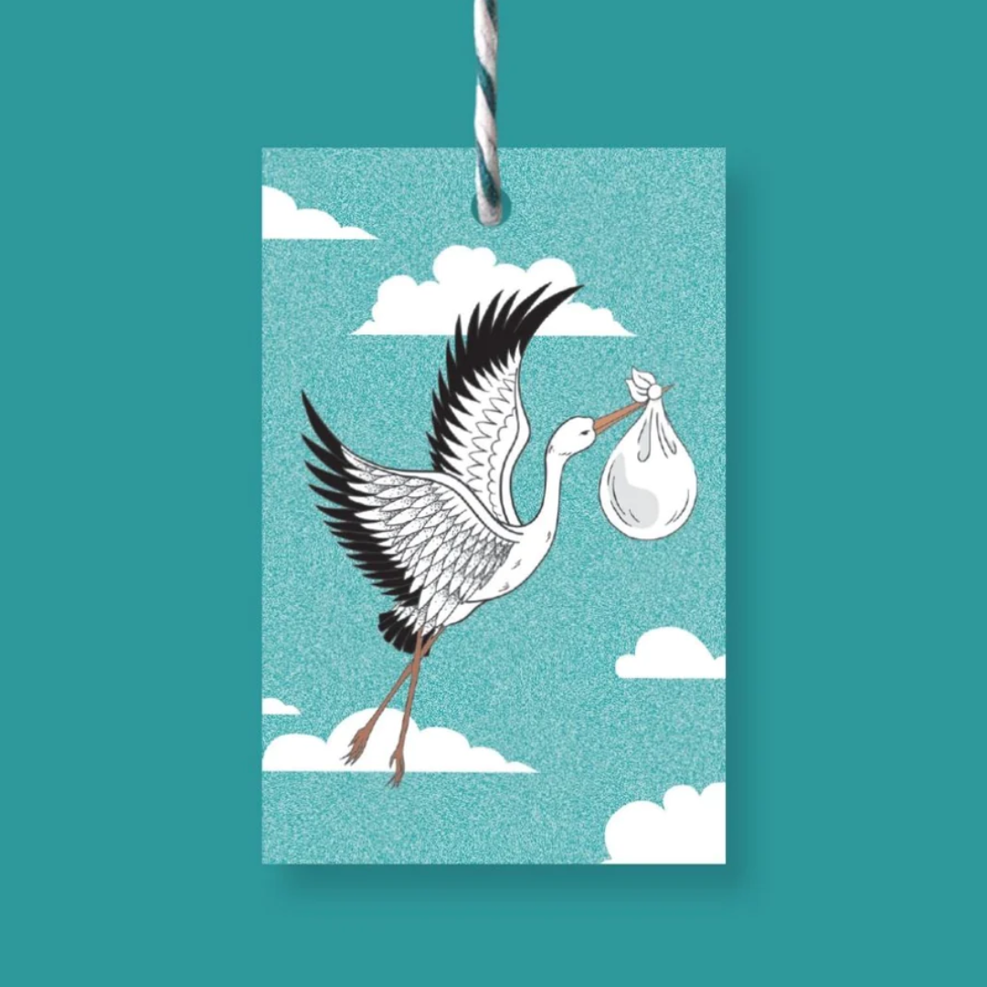 Rectangular baby shower gift tag featuring a stork carrying a baby in a sack against a teal sky with clouds.