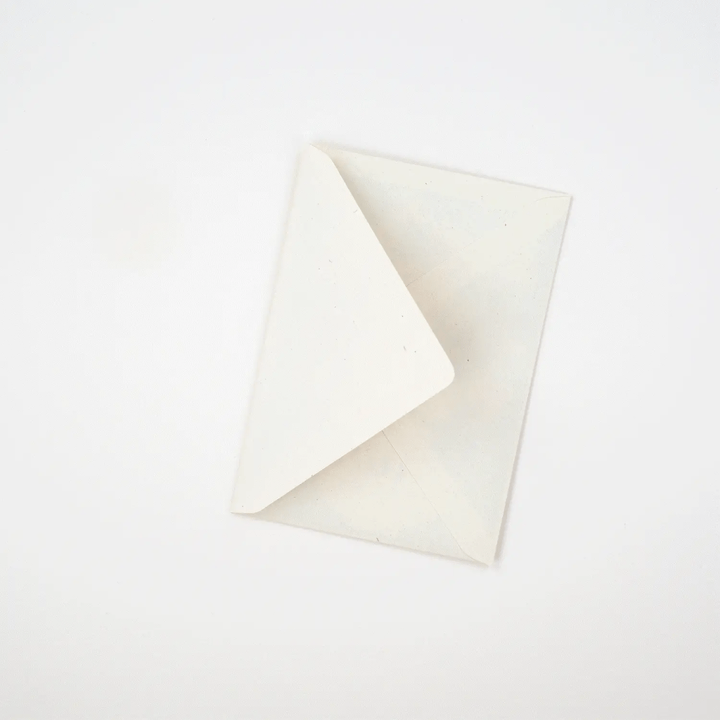Off-white, rectangular envelope with a pointed flap, lying flat on a white background.