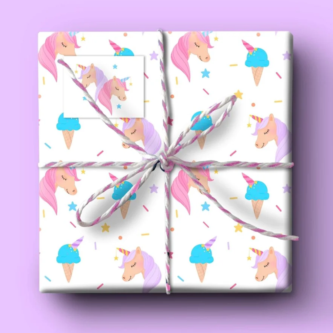 Gift wrap featuring a repeating pattern of pastel unicorns and ice cream cones on a white background.