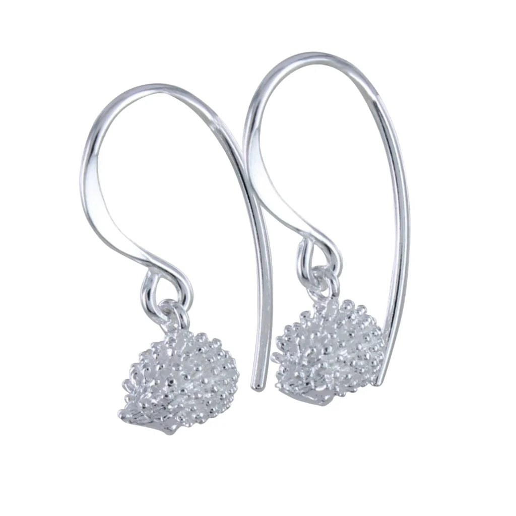 Pair of silver hedgehog drop earrings.  Each earring features a textured hedgehog charm dangling from a curved wire hook.