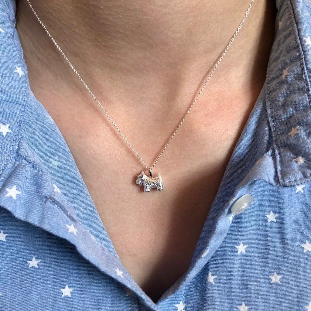 Silver necklace featuring a small, textured Scottie dog pendant.