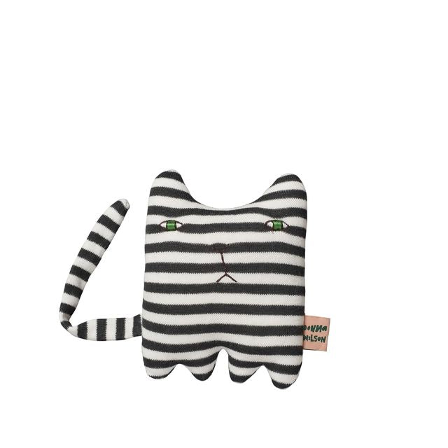 Black and white striped cat-shaped toy with green eyes on a white background