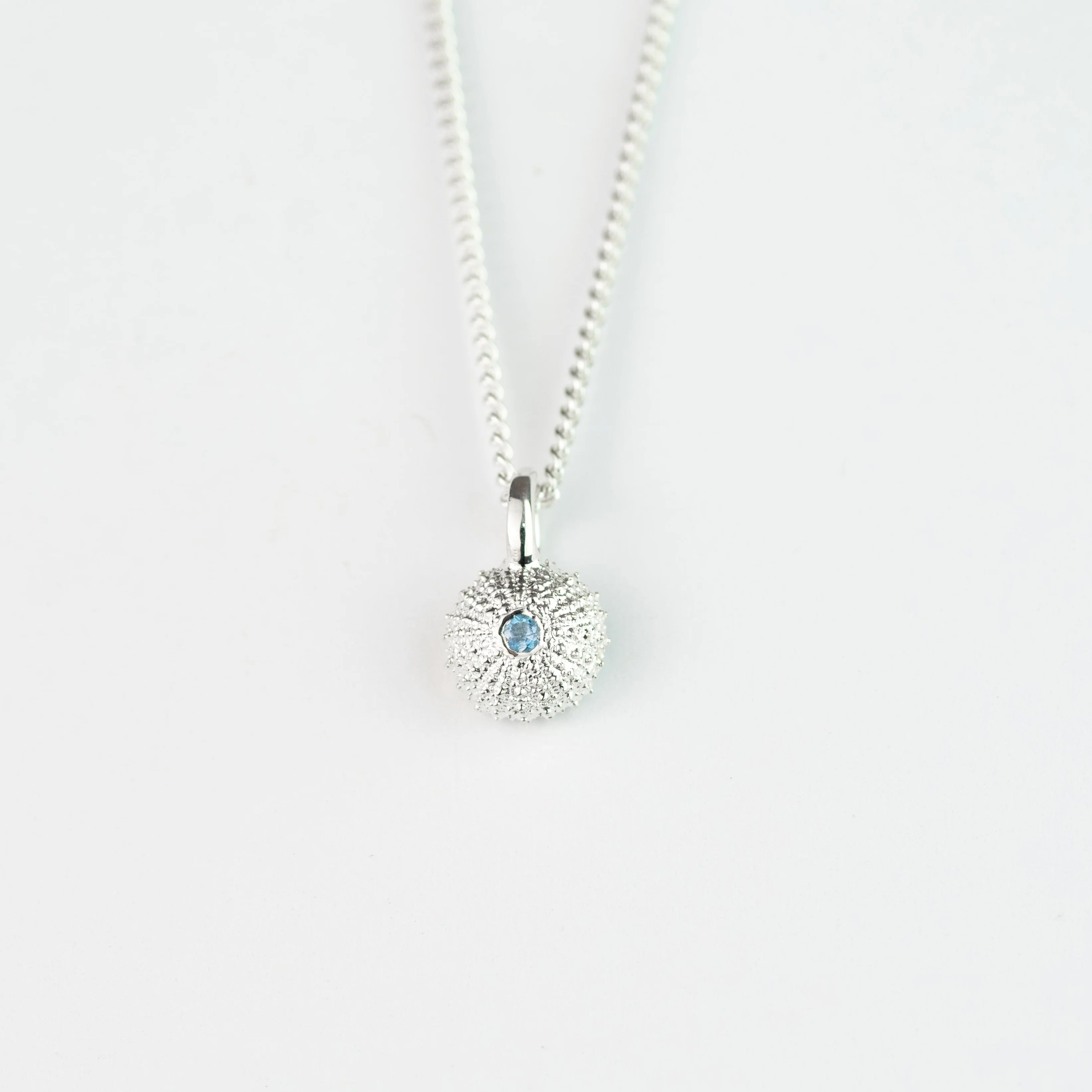 Necklace with a sunflower pendant on a white background