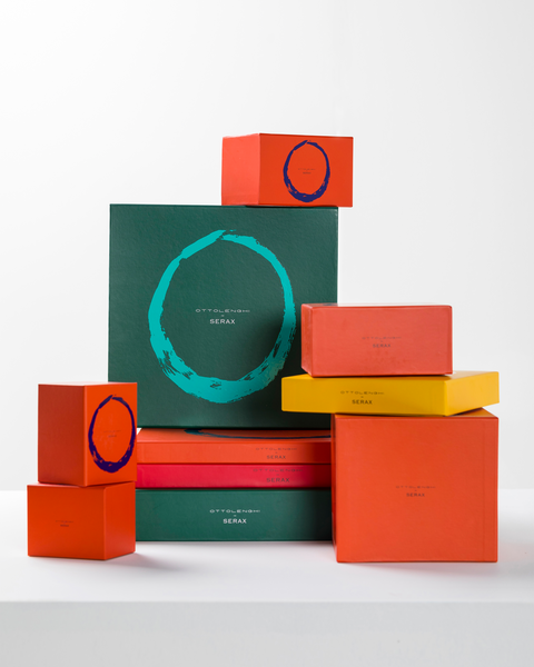 stacked orange, green, yellow and pink outer packaging boxes, for products from the  FEAST tableware collection, designed by British-Israeli chef Yotam Ottolenghi, for Belgian design brand Serax.