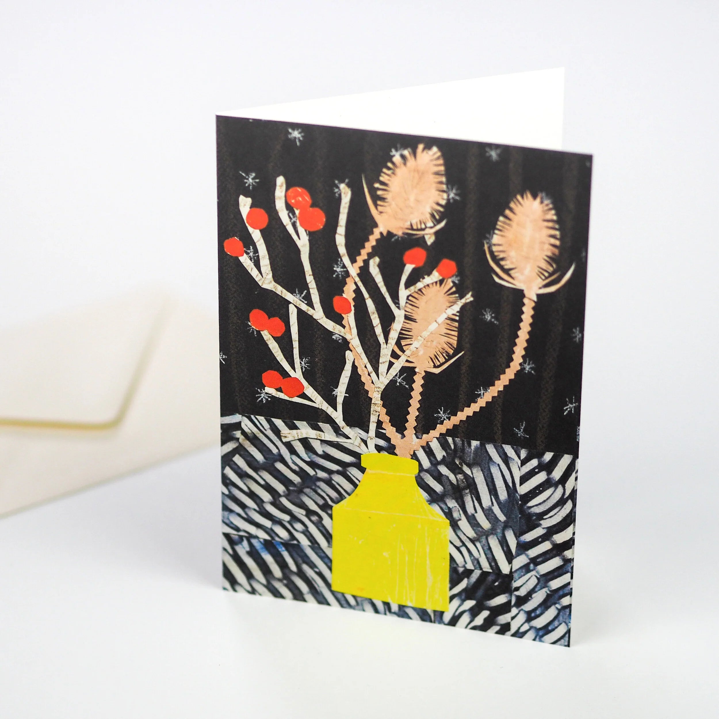 Greeting card featuring a stylized illustration of winter flora in a yellow vase against a dark background with a patterned