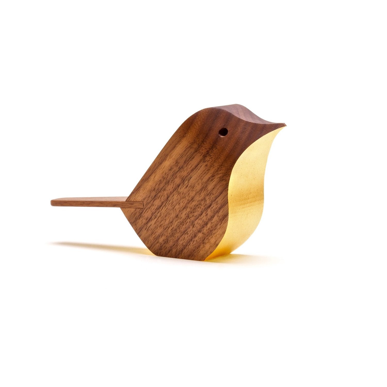 Wooden bird figurine with gold leaf detail.  Simple, stylized design.