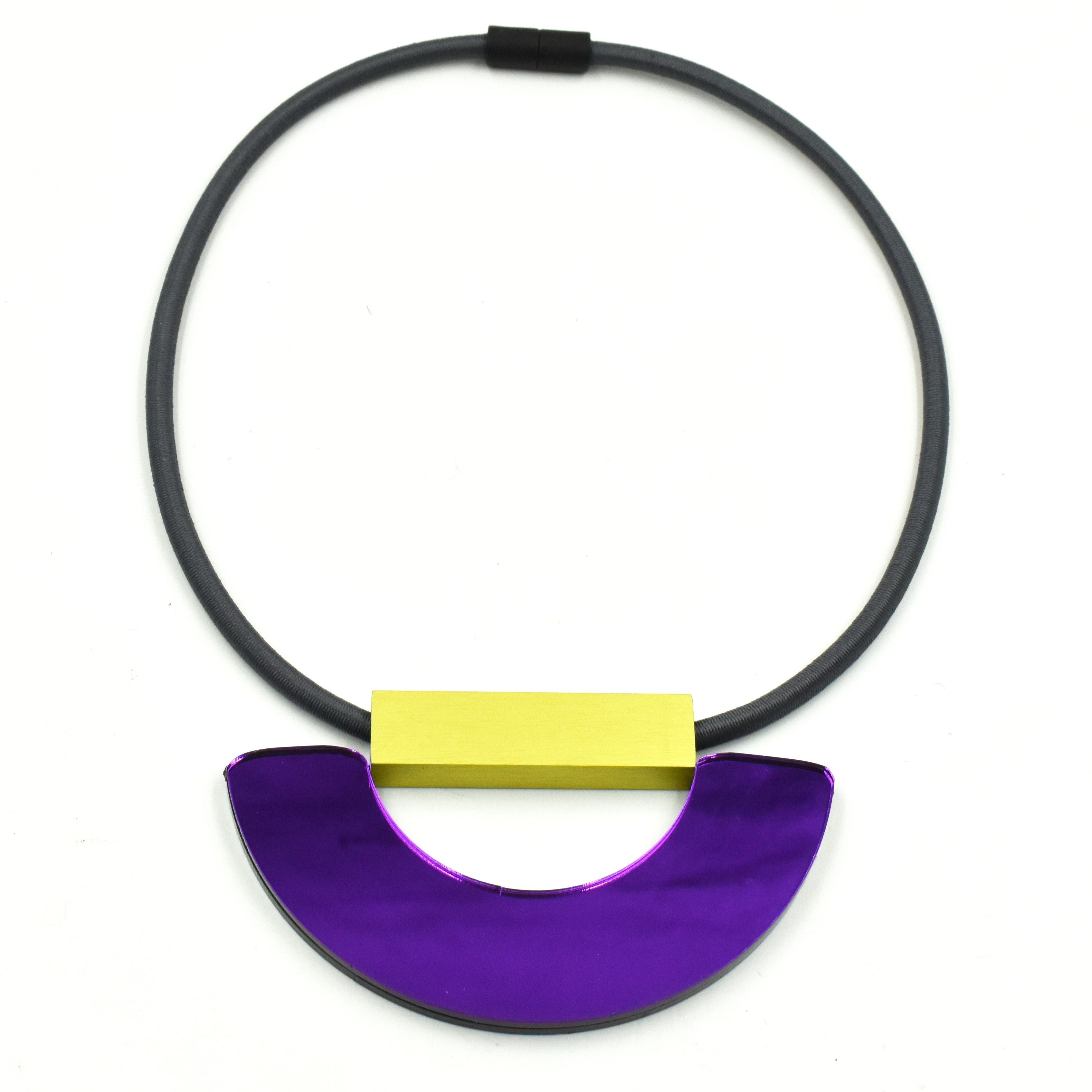 Purple and gold statement necklace with a semi-circular pendant and gray elastic cord.