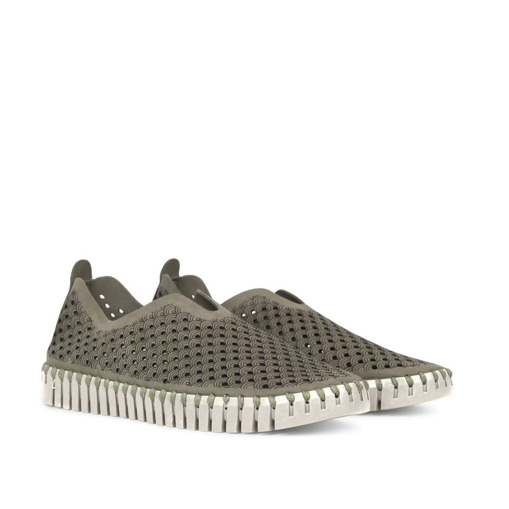 Pair of olive-green slip-on shoes with a textured, perforated upper and off-white, ridged sole. Darker olive pattern detailing.