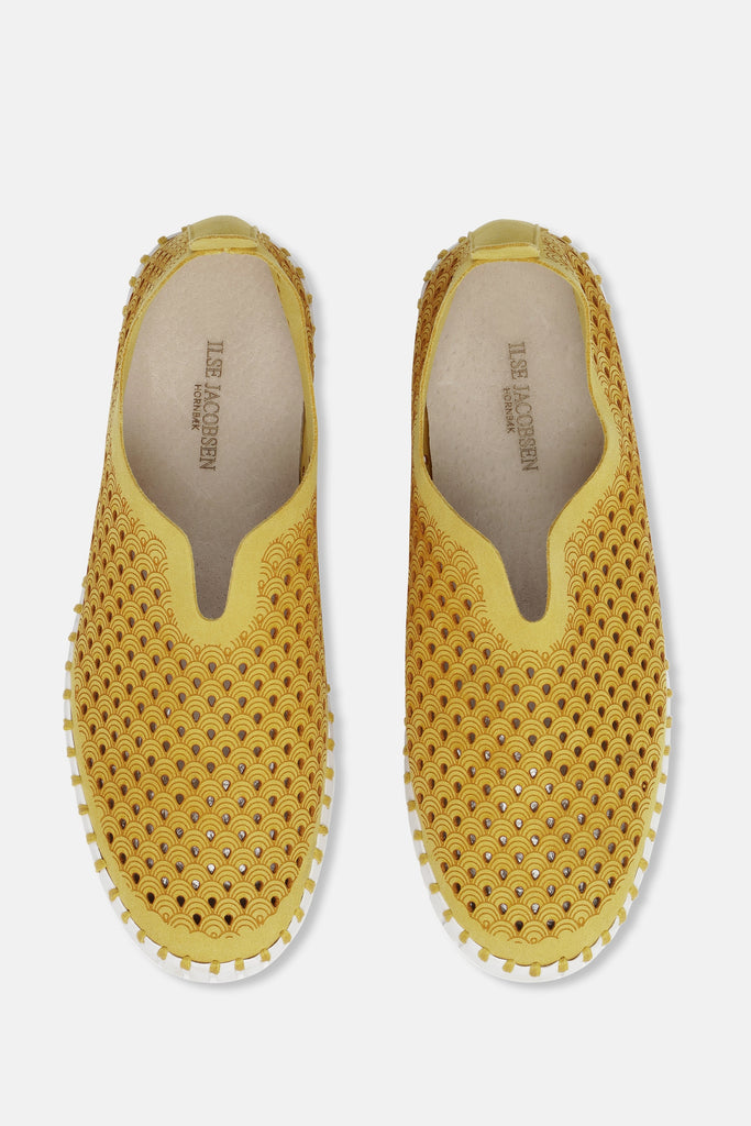 Ilse Jacobsen Hornbæk yellow leather slip-on shoes with a wave pattern cutout design and white trim.