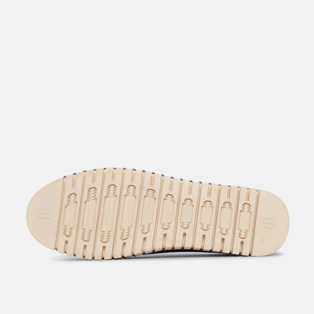 Cream-colored shoe sole with a textured, patterned tread and a navy blue strip along the edge. The sole shows a brand marking.