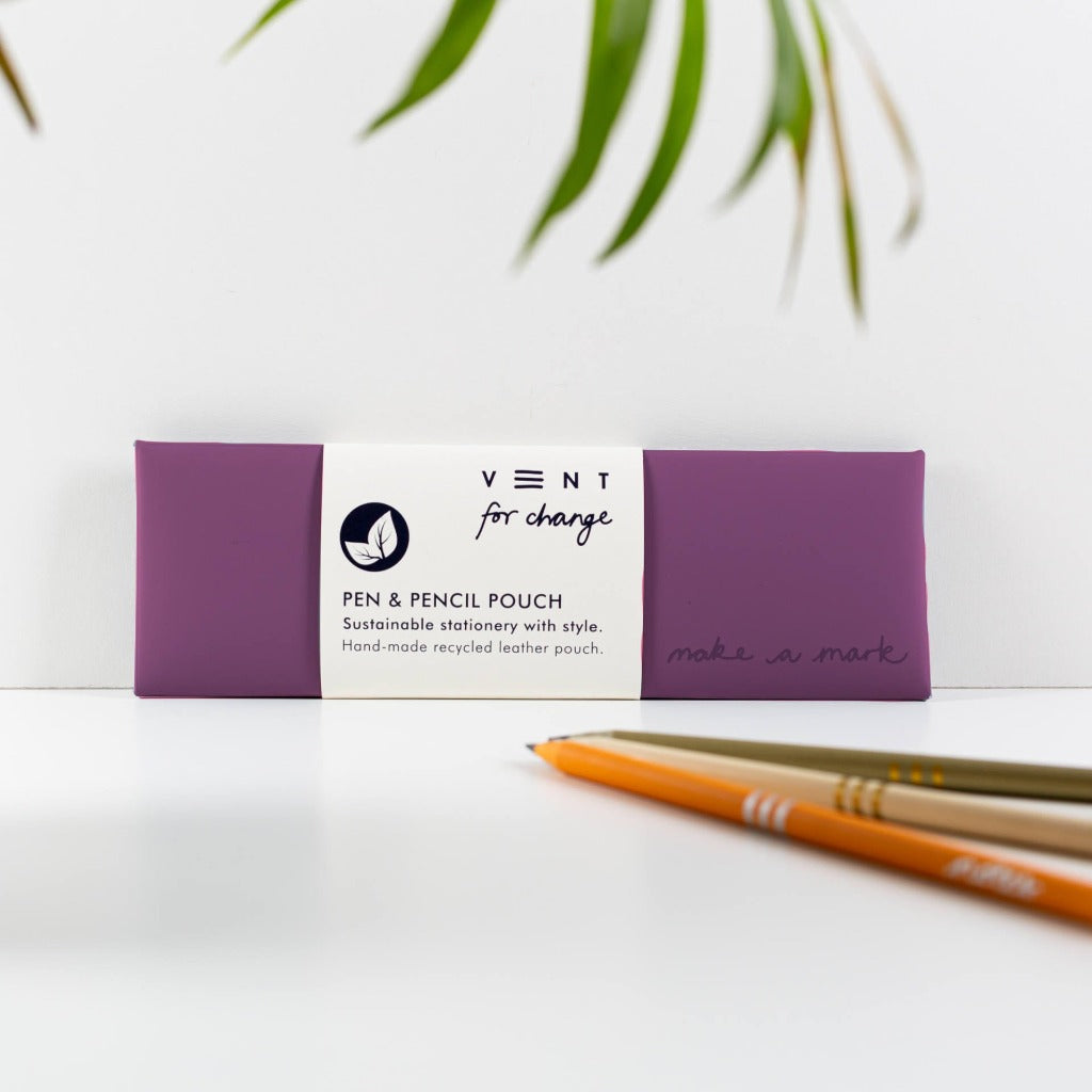 Purple recycled leather pen and pencil pouch; "VENT for change" and "make a mark" text on pouch.