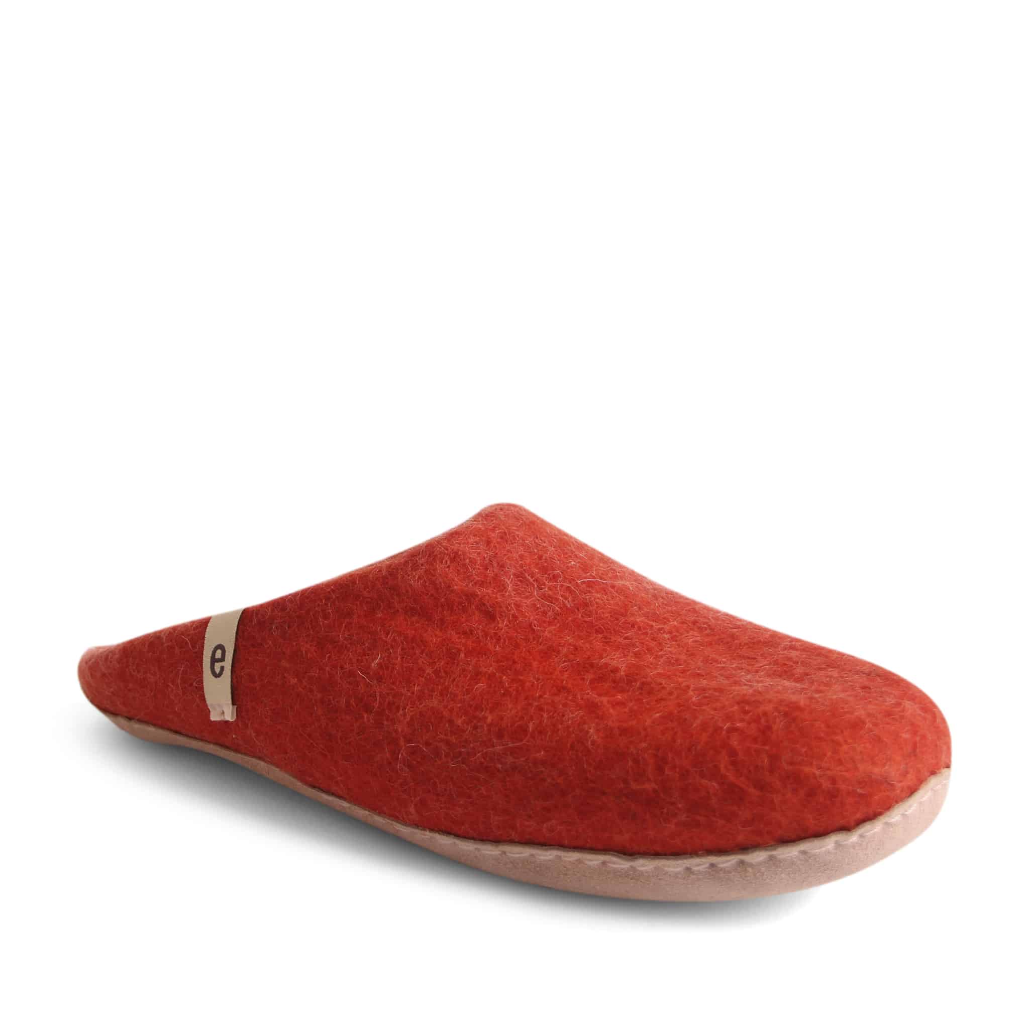 Red felt slipper with a light beige sole and small label.