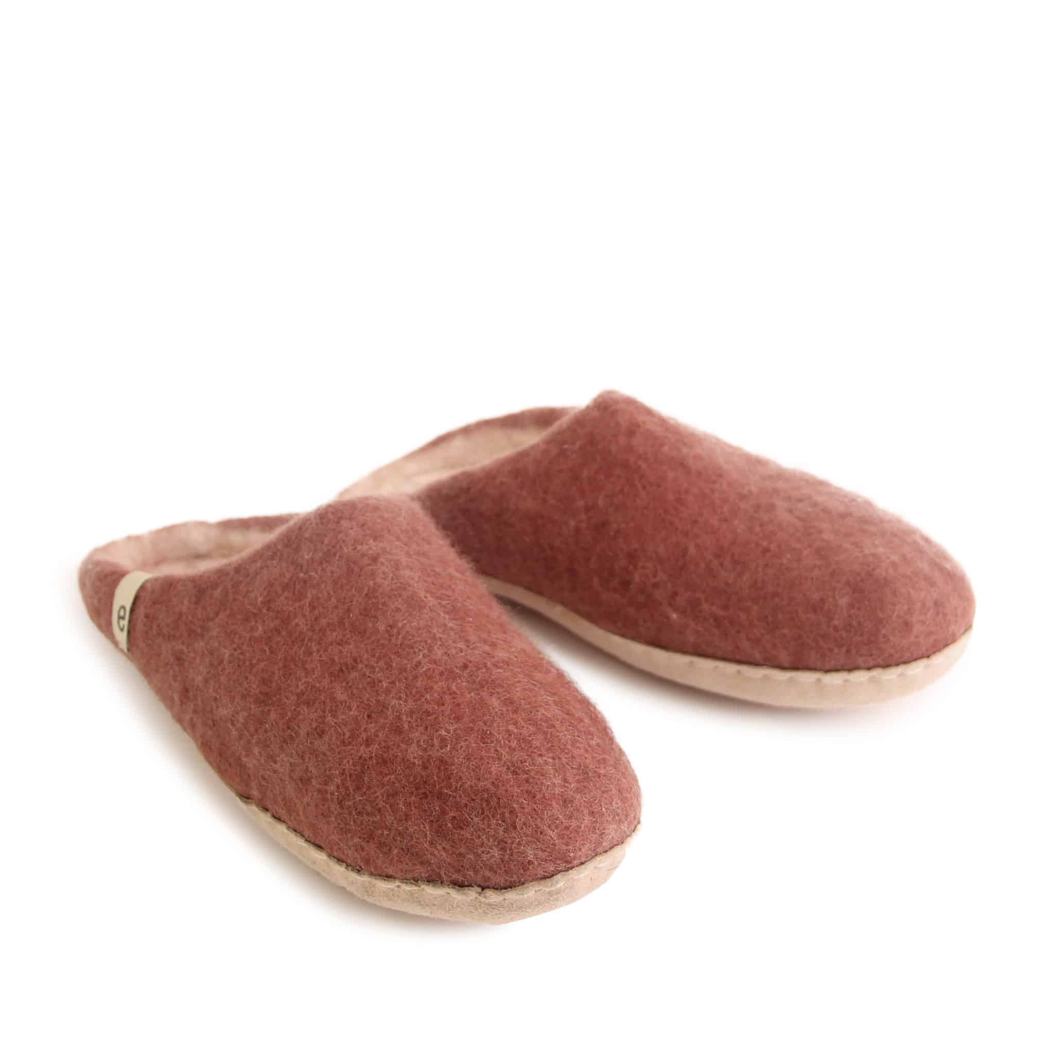Pair of dusty rose felted wool slippers with light pink soles.