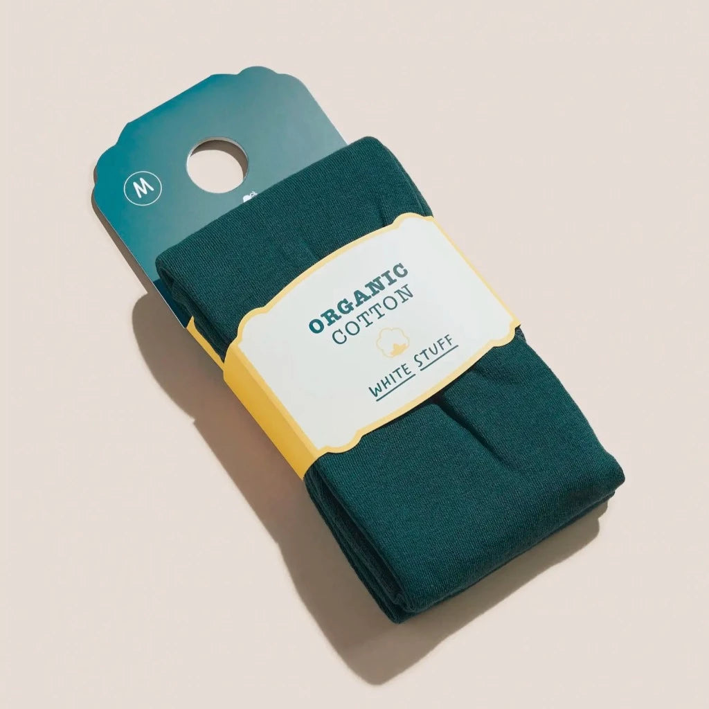 Dark teal organic cotton socks folded on a beige background, size M, with a yellow and white label.