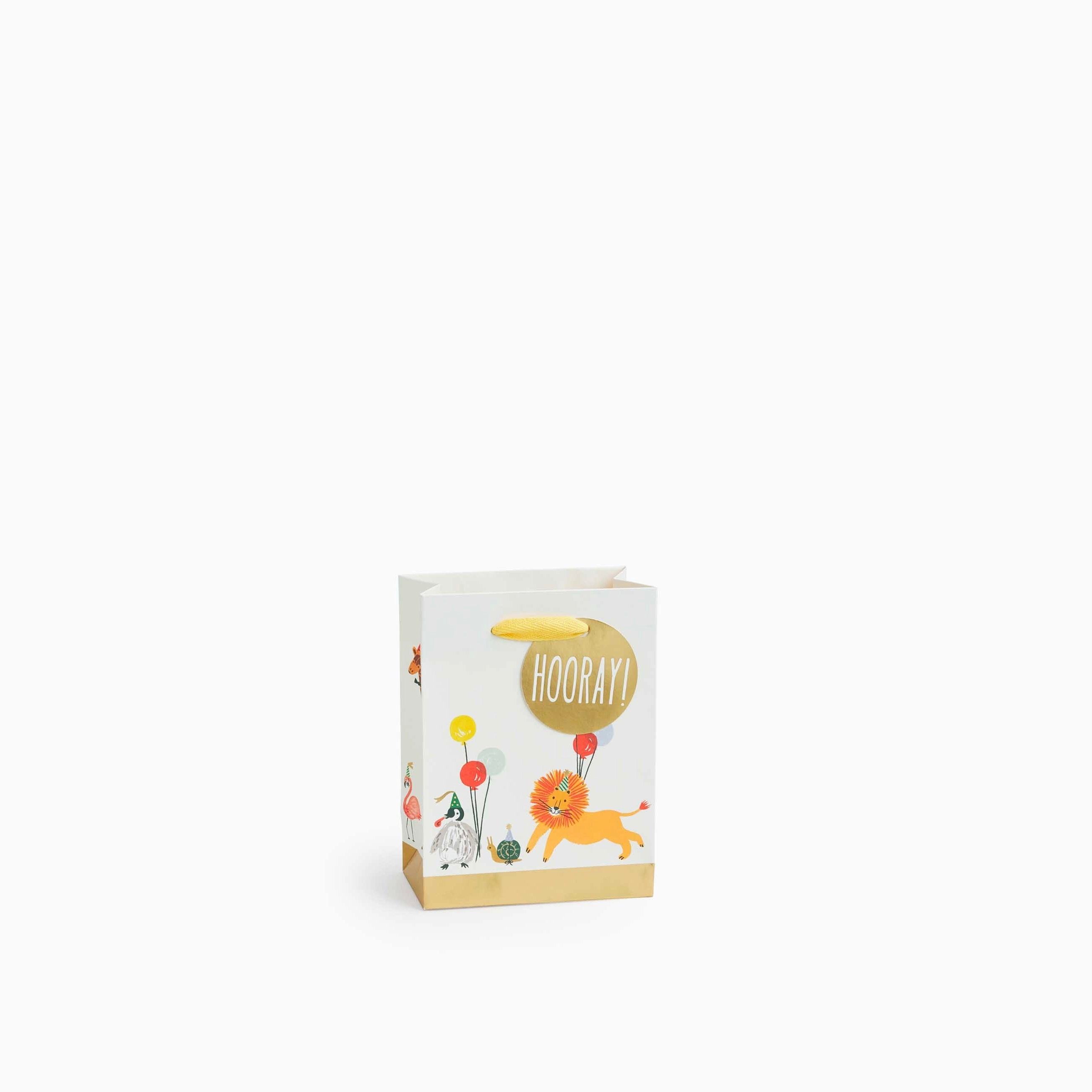 White gift bag with a gold bottom border, featuring a lion, other animals, and balloons.  A gold tag says "Hooray!".