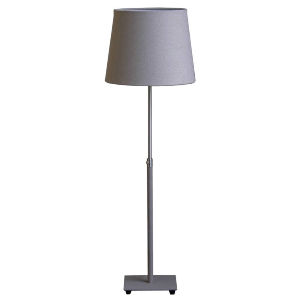Gray floor lamp with a cylindrical base and a light gray fabric shade.