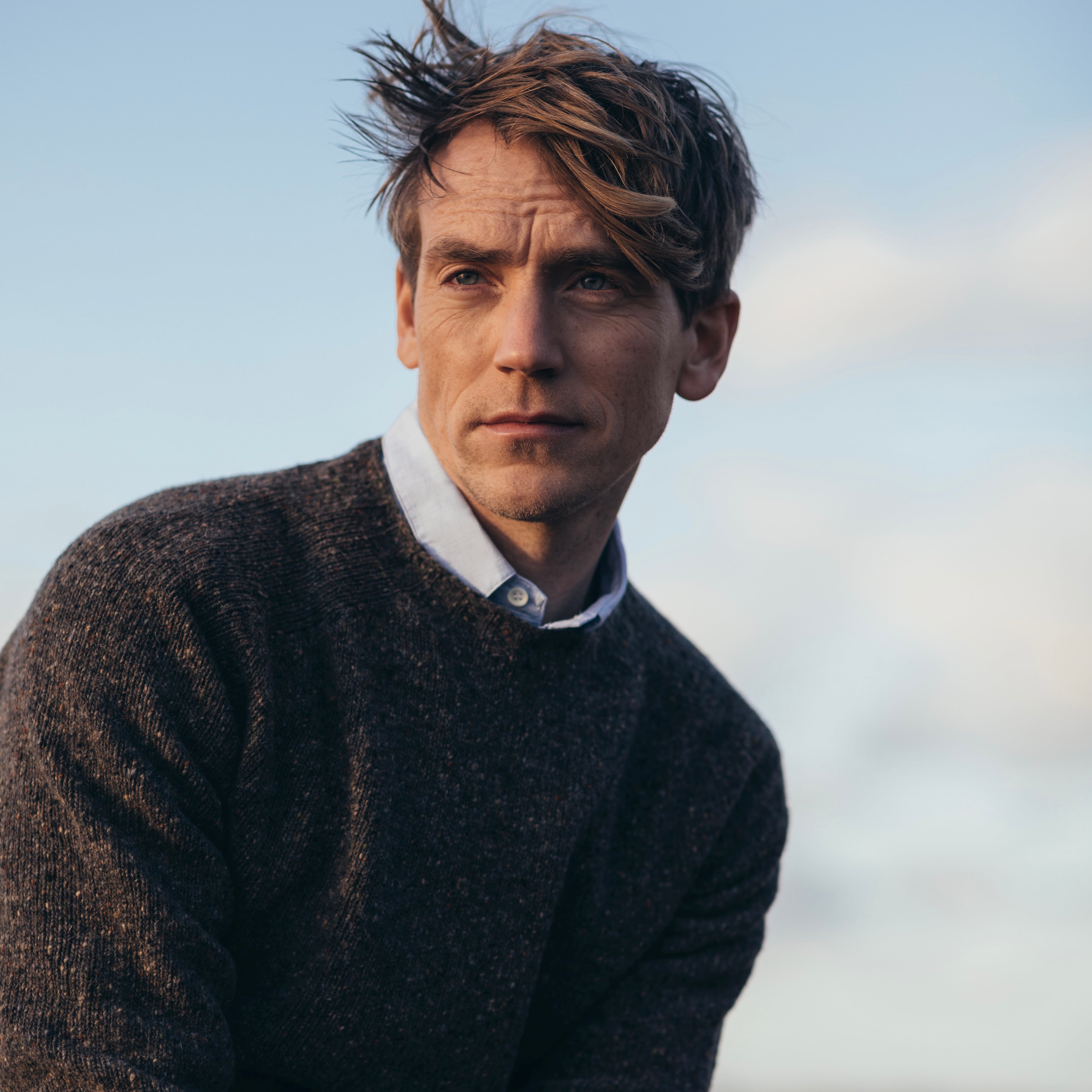 head shot of a male model with hands held together, wearing a Harley of Scotland Men's Jumper -Staffa